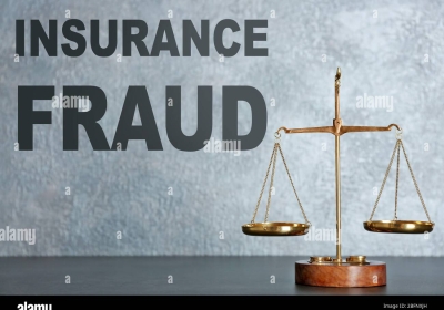 insurance-fraud-concept-scales-of-justice-on-table-2BFNXJH
